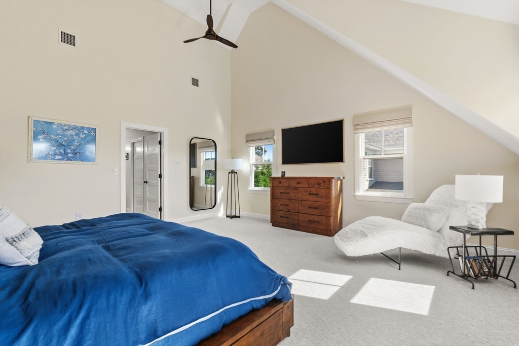 37 Moorland Road Scituate, MA 02066 - Photo 17 of 38 a spacious bedroom with a bed and a flat screen television