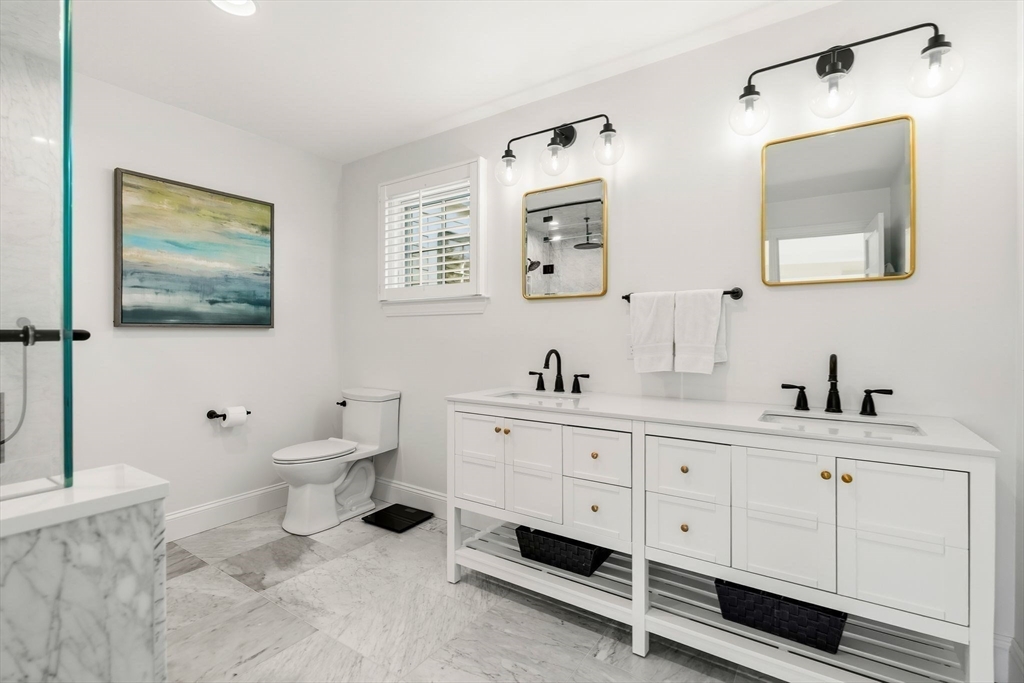 37 Moorland Road Scituate, MA 02066 - Photo 19 of 38 a spacious bathroom with 2 sink toilet and a mirror