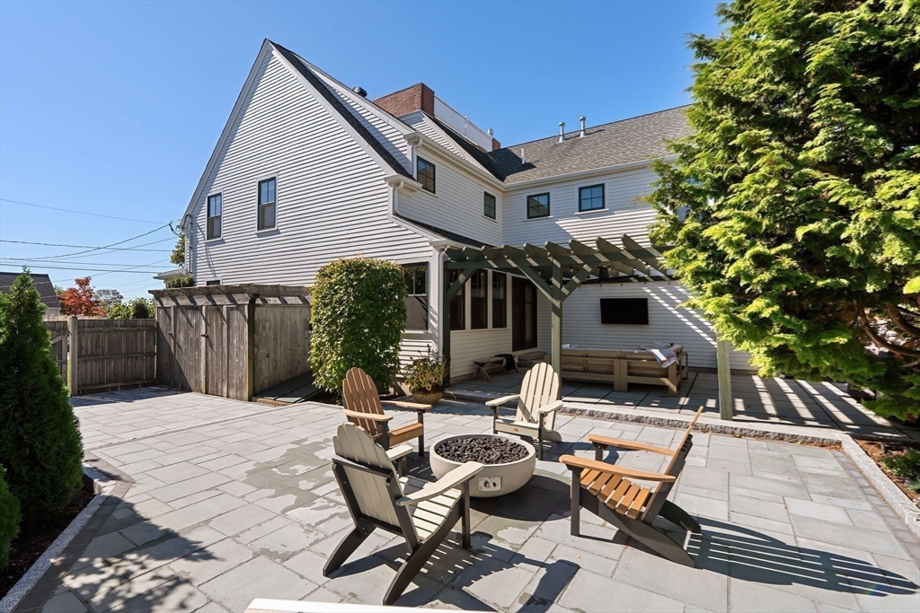 37 Moorland Road Scituate, MA 02066 - Photo 32 of 38 a view of a patio with table and chairs and floor to ceiling window