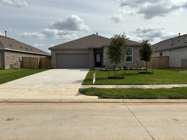 26419 Virginia Wild Rye Lane Katy, TX 77493 - Photo 1 of 31 This is a modern single-story home with a brick exterior and a spacious driveway leading to a two-car garage. The front yard is neatly landscaped with young trees and a small lawn.