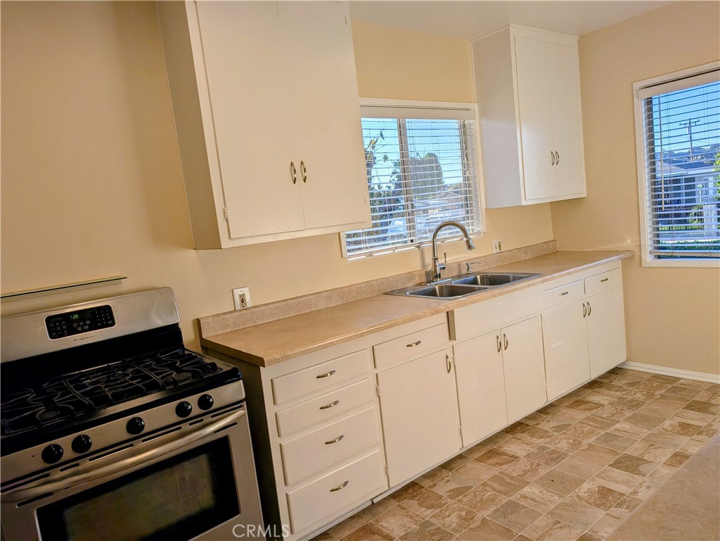 544 Laurel Avenue Brea, CA 92821 - Photo 8 of 15 a kitchen with granite countertop cabinets and window