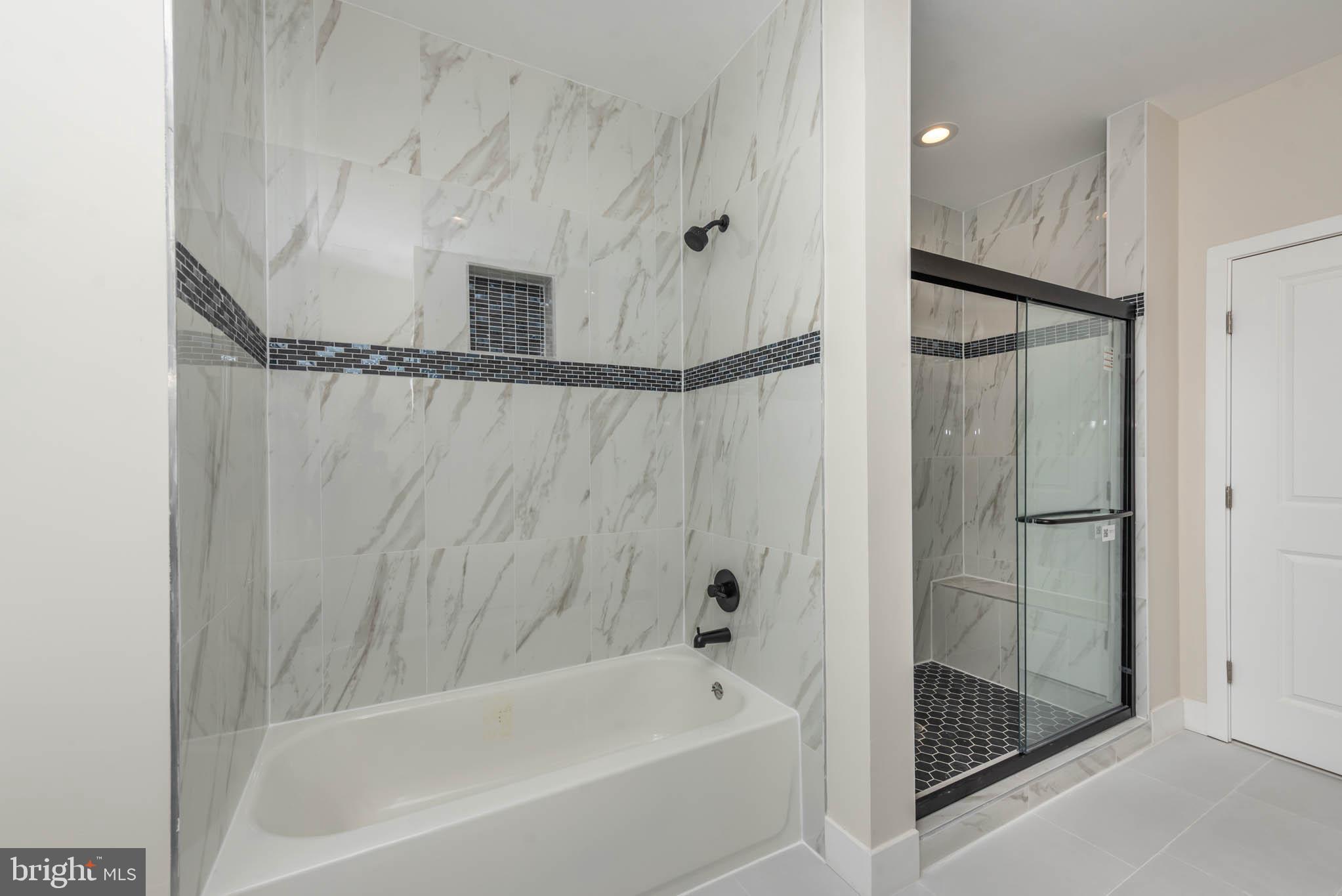 9626 Harford Road Parkville, MD 21234 - Photo 15 of 33 a bathroom with a bathtub and a shower