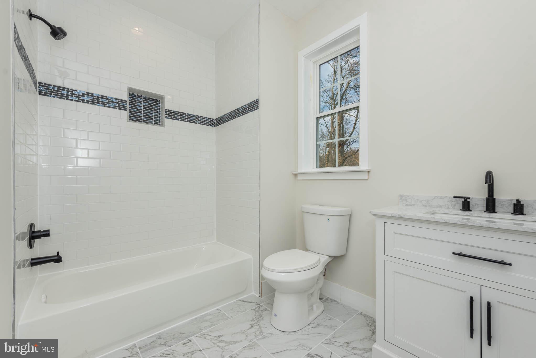 9626 Harford Road Parkville, MD 21234 - Photo 20 of 34 a bathroom with a sink a toilet and a bathtub