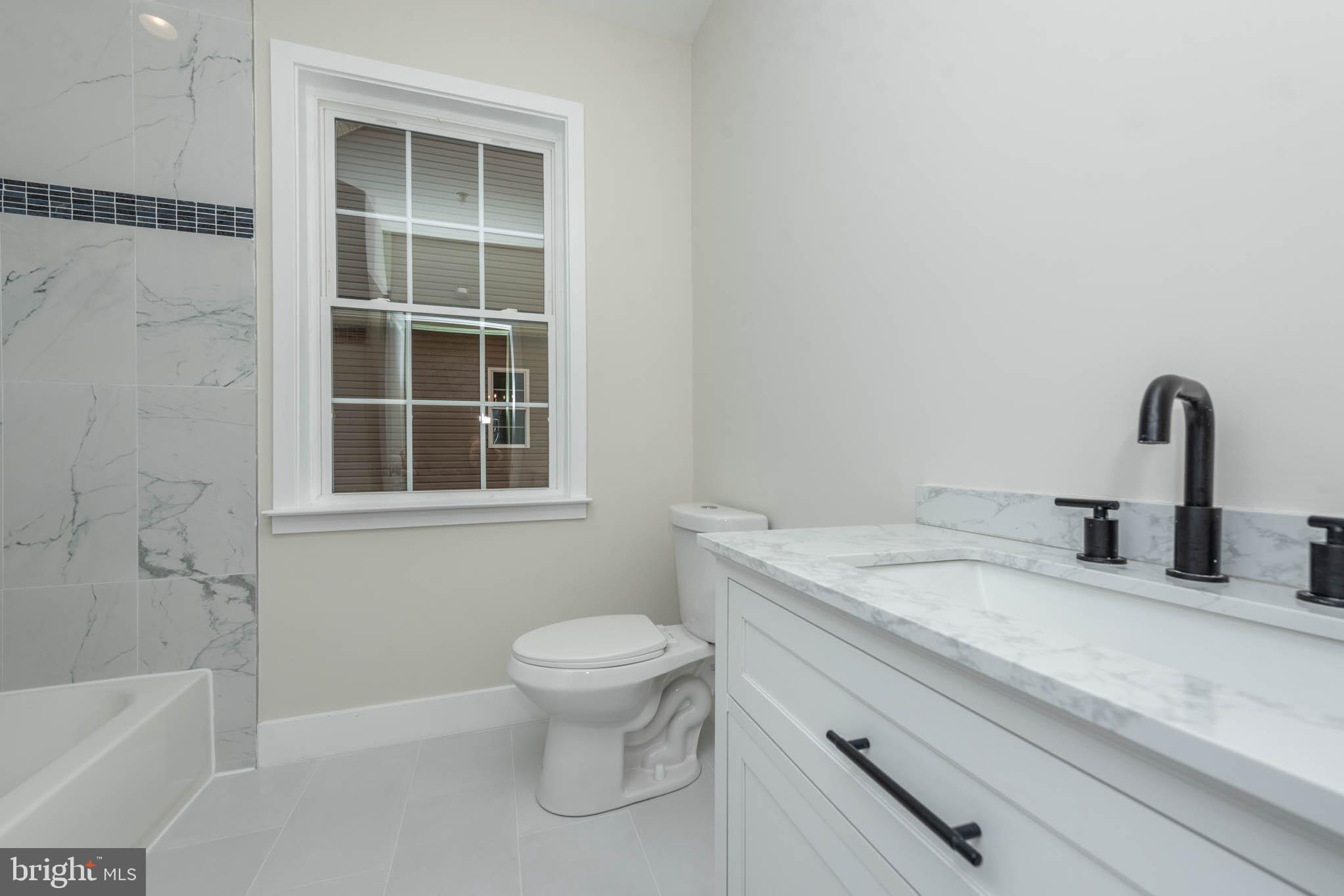 9626 Harford Road Parkville, MD 21234 - Photo 22 of 33 a bathroom with a sink and a toilet