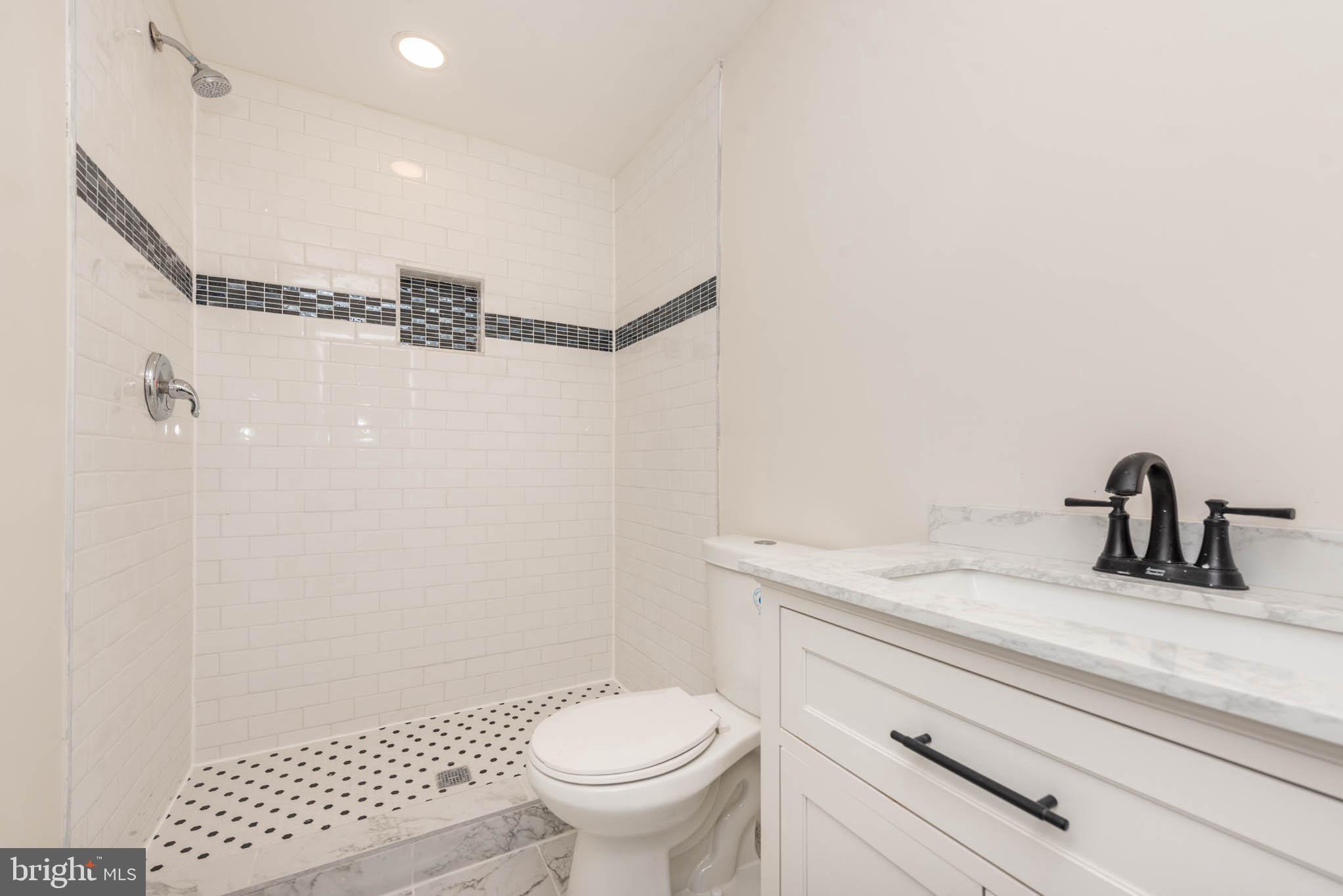 9626 Harford Road Parkville, MD 21234 - Photo 30 of 33 a bathroom with a granite countertop sink toilet and shower