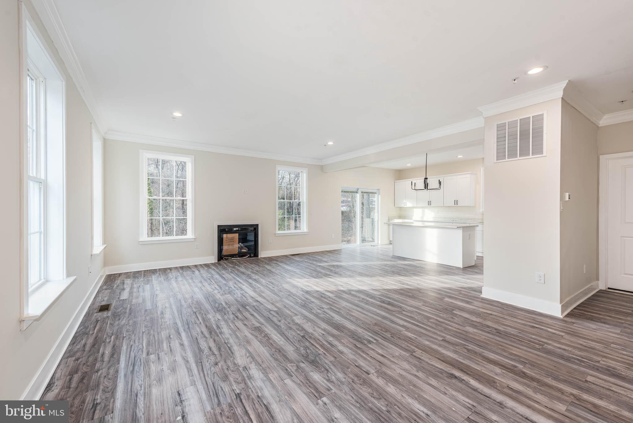 9626 Harford Road Parkville, MD 21234 - Photo 5 of 33 a view of empty room with wooden floor and fireplace