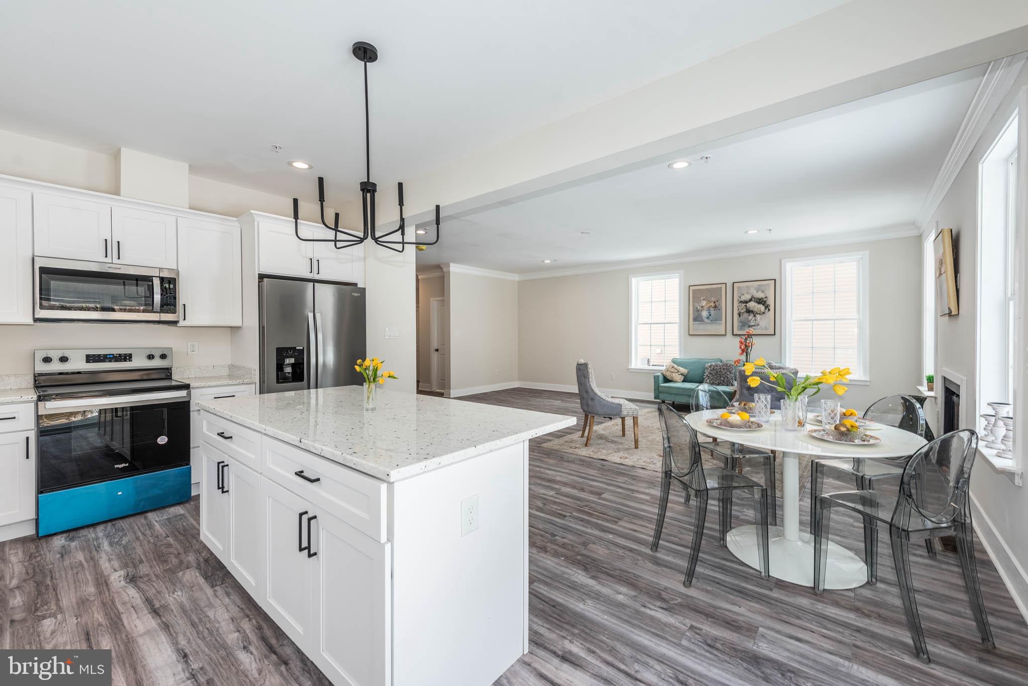 9626 Harford Road Parkville, MD 21234 - Photo 5 of 34 a room with stainless steel appliances kitchen island granite countertop a stove top oven a sink a dining table and chairs
