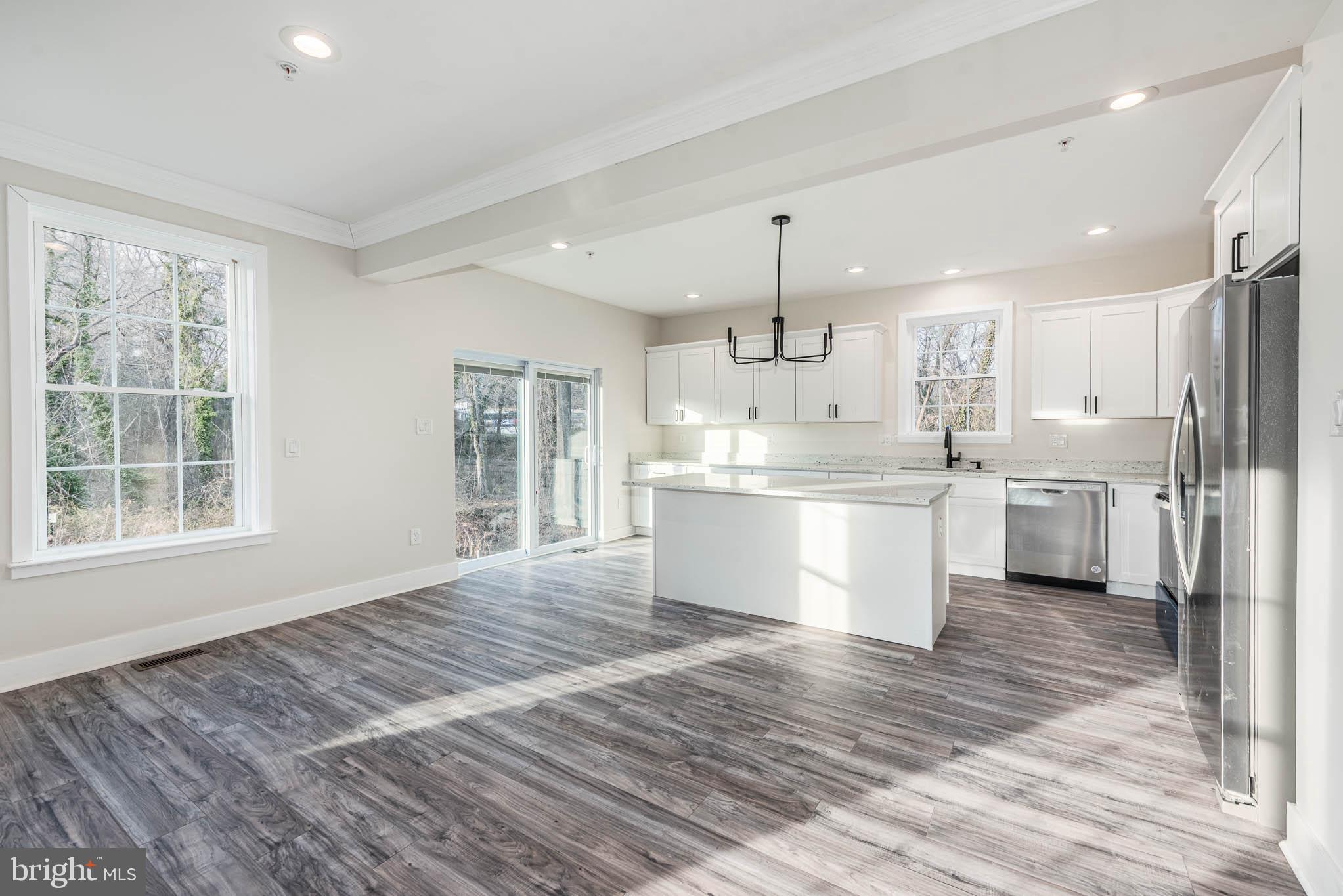 9626 Harford Road Parkville, MD 21234 - Photo 6 of 33 a large kitchen with kitchen island a sink stainless steel appliances and cabinets