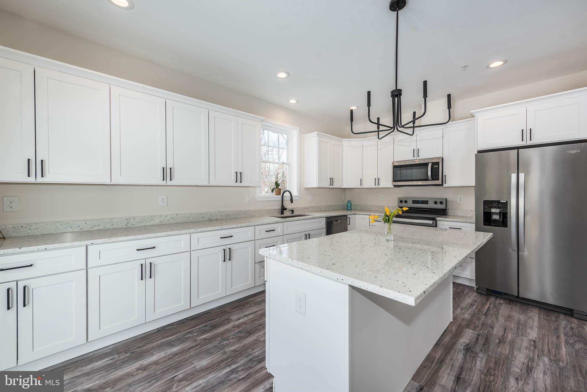 9626 Harford Road Parkville, MD 21234 - Photo 8 of 34 a kitchen with kitchen island white cabinets stainless steel appliances and sink