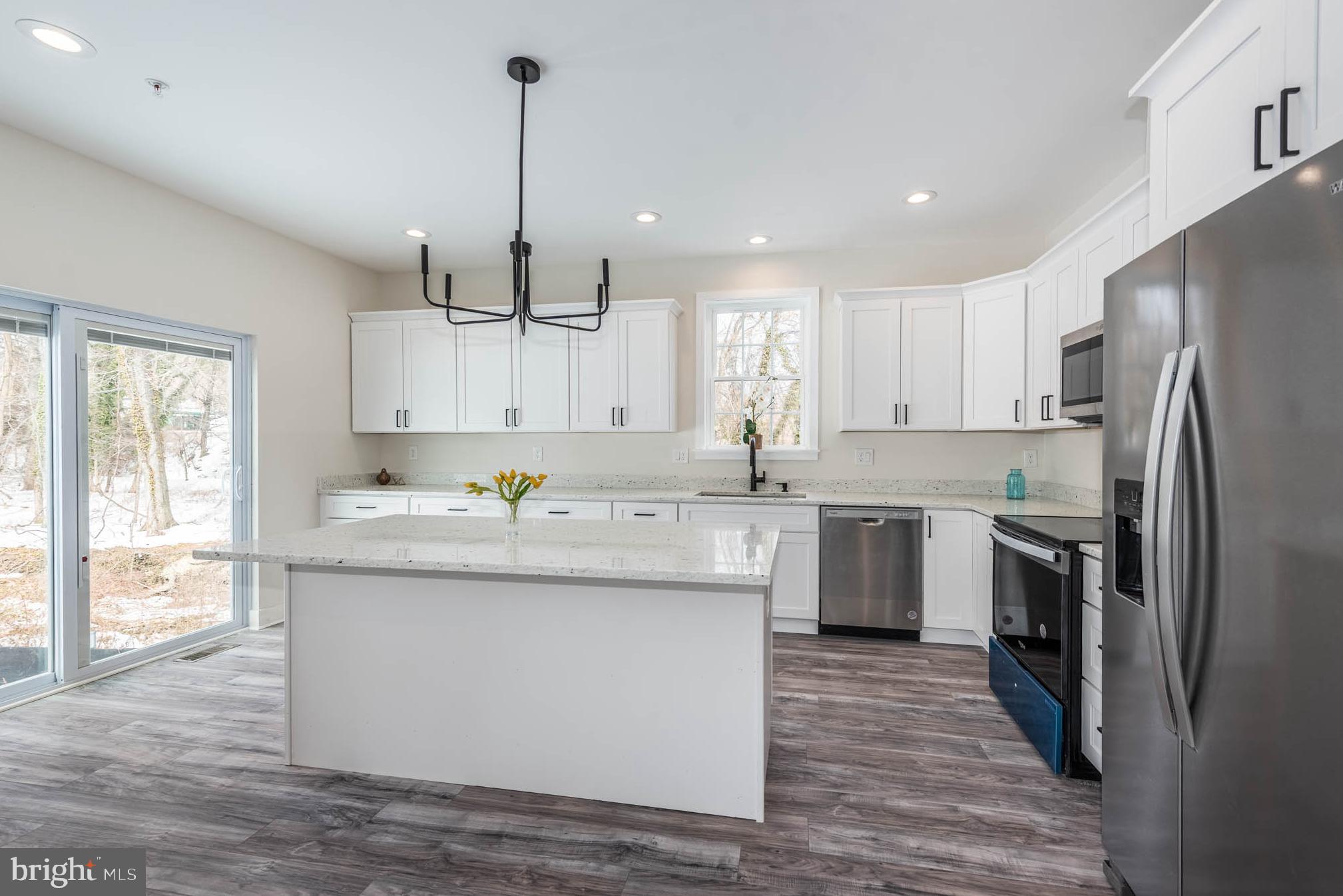 9626 Harford Road Parkville, MD 21234 - Photo 9 of 34 a kitchen with kitchen island granite countertop a sink refrigerator and cabinets