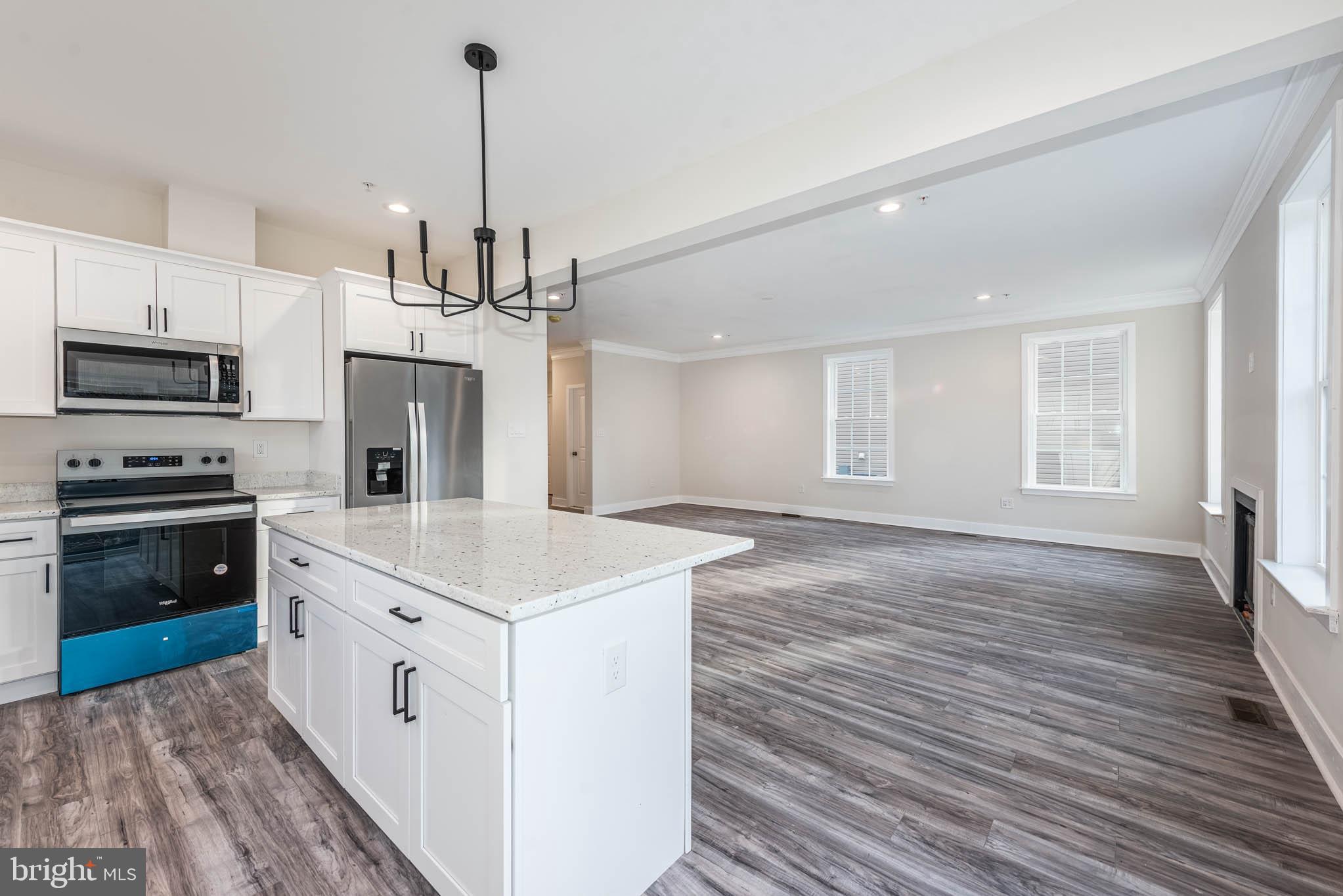 9626 Harford Road Parkville, MD 21234 - Photo 9 of 33 a kitchen with stove cabinets and wooden floor