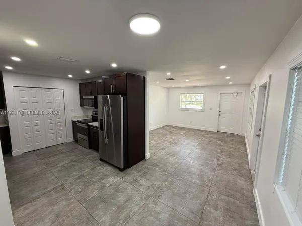 a kitchen with stainless steel appliances a refrigerator and cabinets
