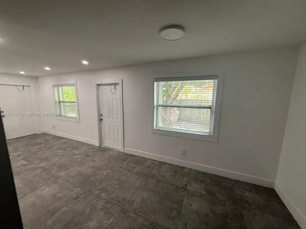 an entryway door with a hallway in the background
