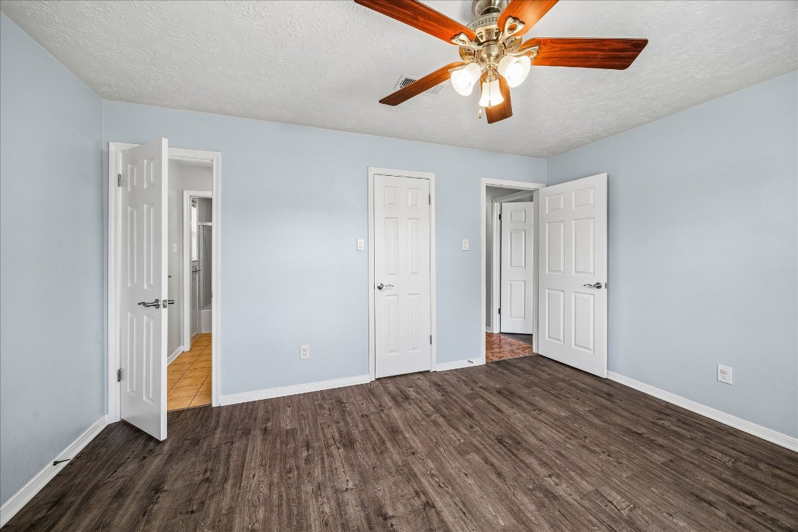 25732 Chestnut Lane Splendora, TX 77372 - Photo 17 of 27 Primary bedroom with access to the ensuite bathroom, walk-in closet, and hallway