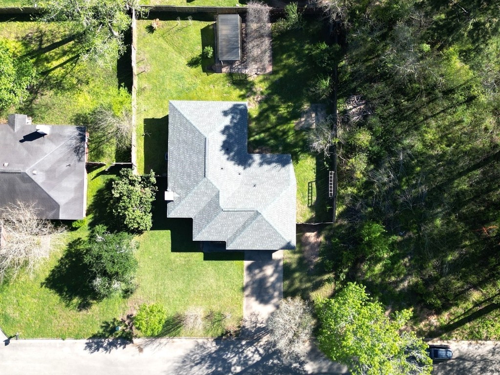 25732 Chestnut Lane Splendora, TX 77372 - Photo 2 of 27 Aerial view highlighting the spacious lot with no direct side neighbor, offering added privacy.