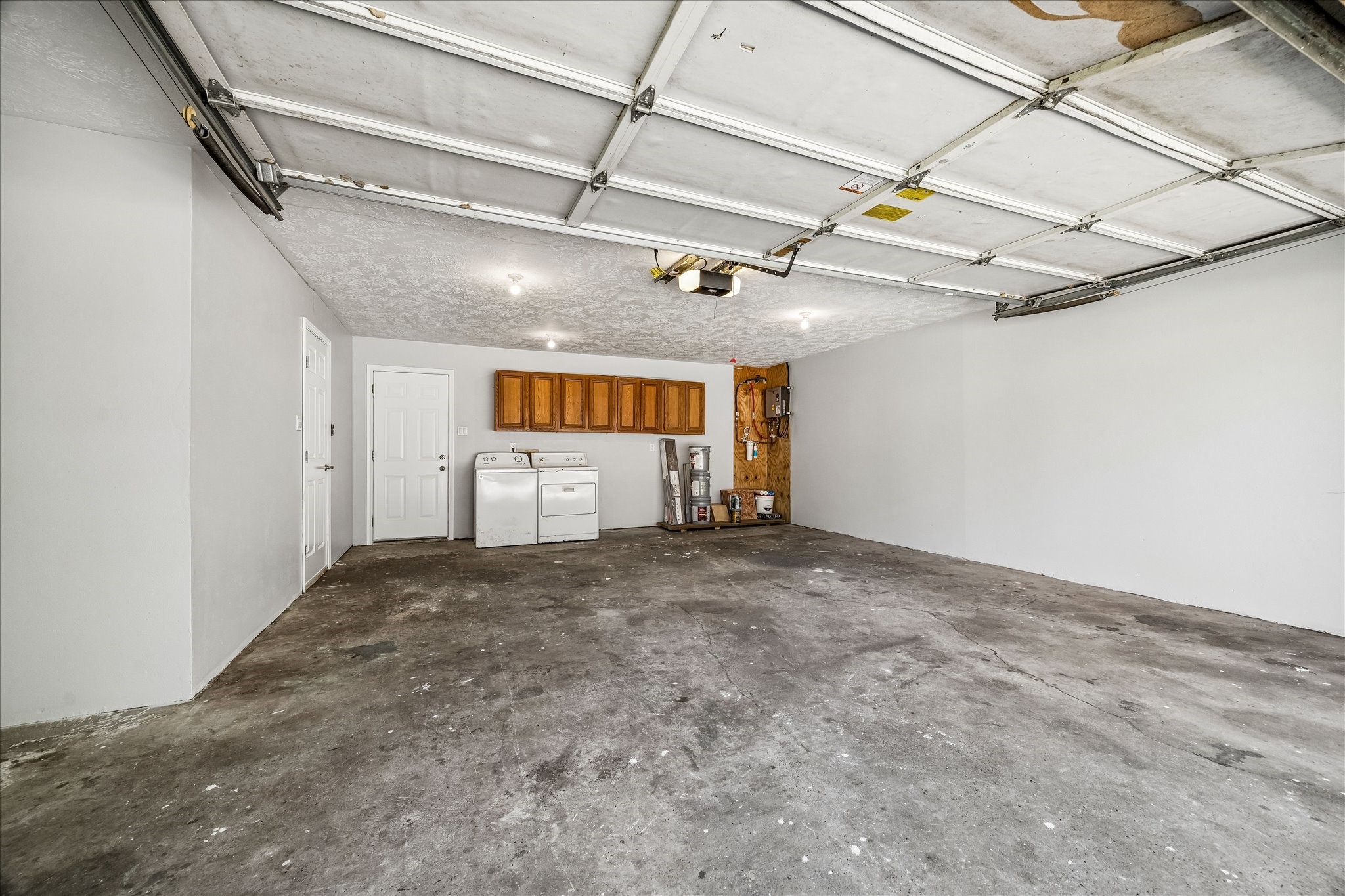 25732 Chestnut Lane Splendora, TX 77372 - Photo 21 of 27 Spacious garage with extra storage space and tankless water heater.