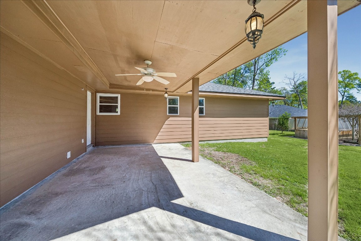 25732 Chestnut Lane Splendora, TX 77372 - Photo 22 of 27 Covered back patio with ceiling fan, ideal for outdoor relaxation or entertaining.