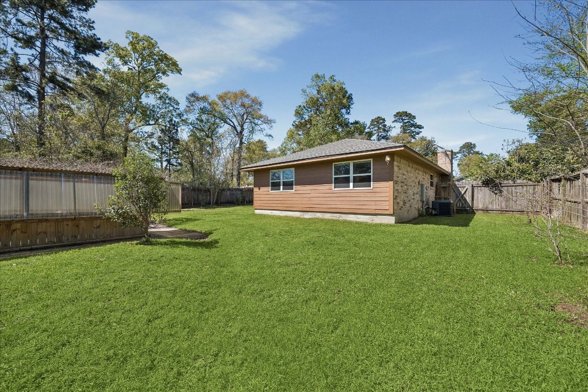 25732 Chestnut Lane Splendora, TX 77372 - Photo 27 of 27 Expansive backyard with mature trees and space to customize.
