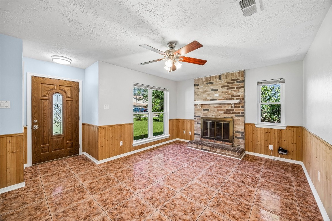25732 Chestnut Lane Splendora, TX 77372 - Photo 5 of 27 Living room with natural light and a brick fireplace feature (currently capped).