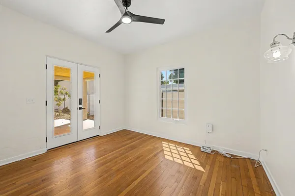 wooden floor in an empty room with a window