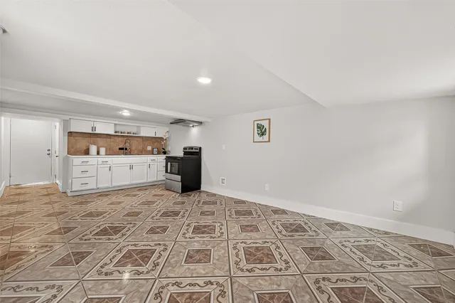 a view of kitchen with microwave and cabinets