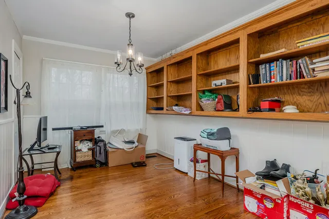 a livingroom with lounge chair and a book shelf