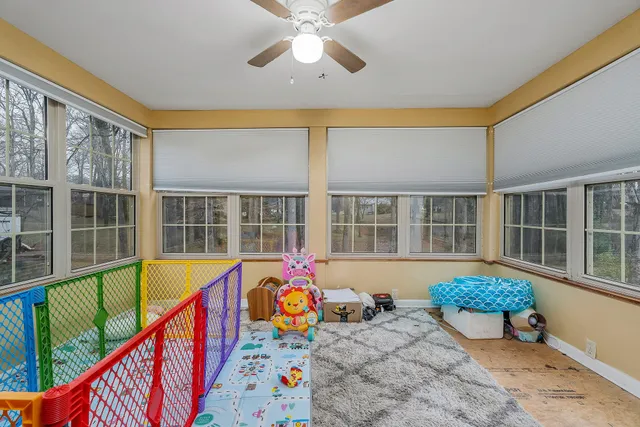 a front view of a house with swimming pool and glass windows