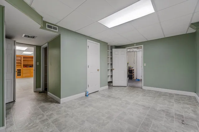 an empty room with closet and a bathroom