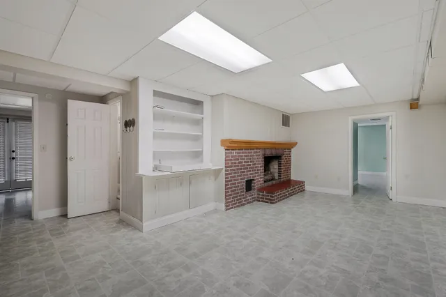 an empty room with furniture and a fireplace