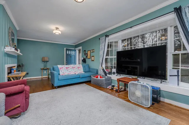 a bedroom with furniture and a flat screen tv