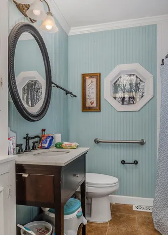 a bathroom with a toilet a sink and a mirror