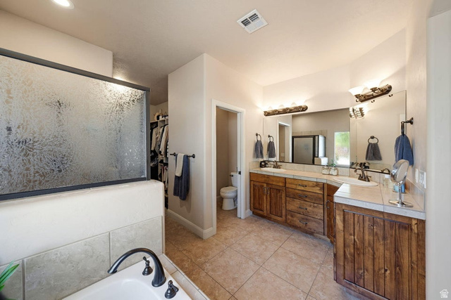 1609 East 10 S Street St. George, UT 84790 - Photo 31 of 68 Full bathroom featuring a frosted glass shower enclosure, dual basin vanity with wood-finish cabinetry, tile countertops, and tiled flooring