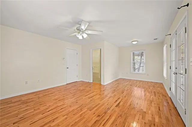 a view of empty room with wooden floor