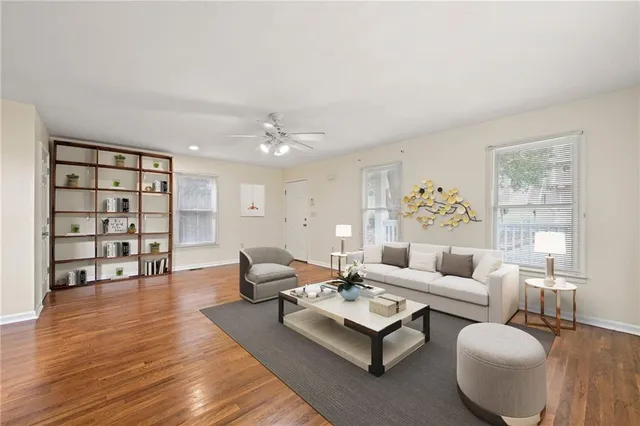a living room with furniture and a wooden floor