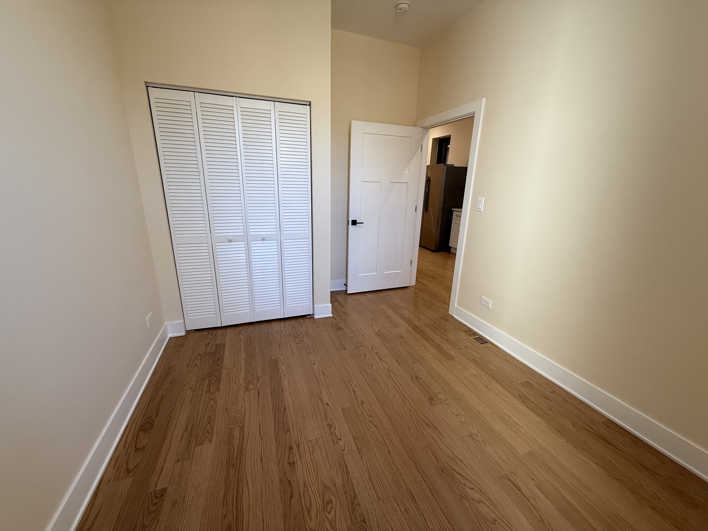 2124 West 18th Place, Unit 1 Chicago, IL 60608 - Photo 11 of 16 an empty room with wooden floor and closet