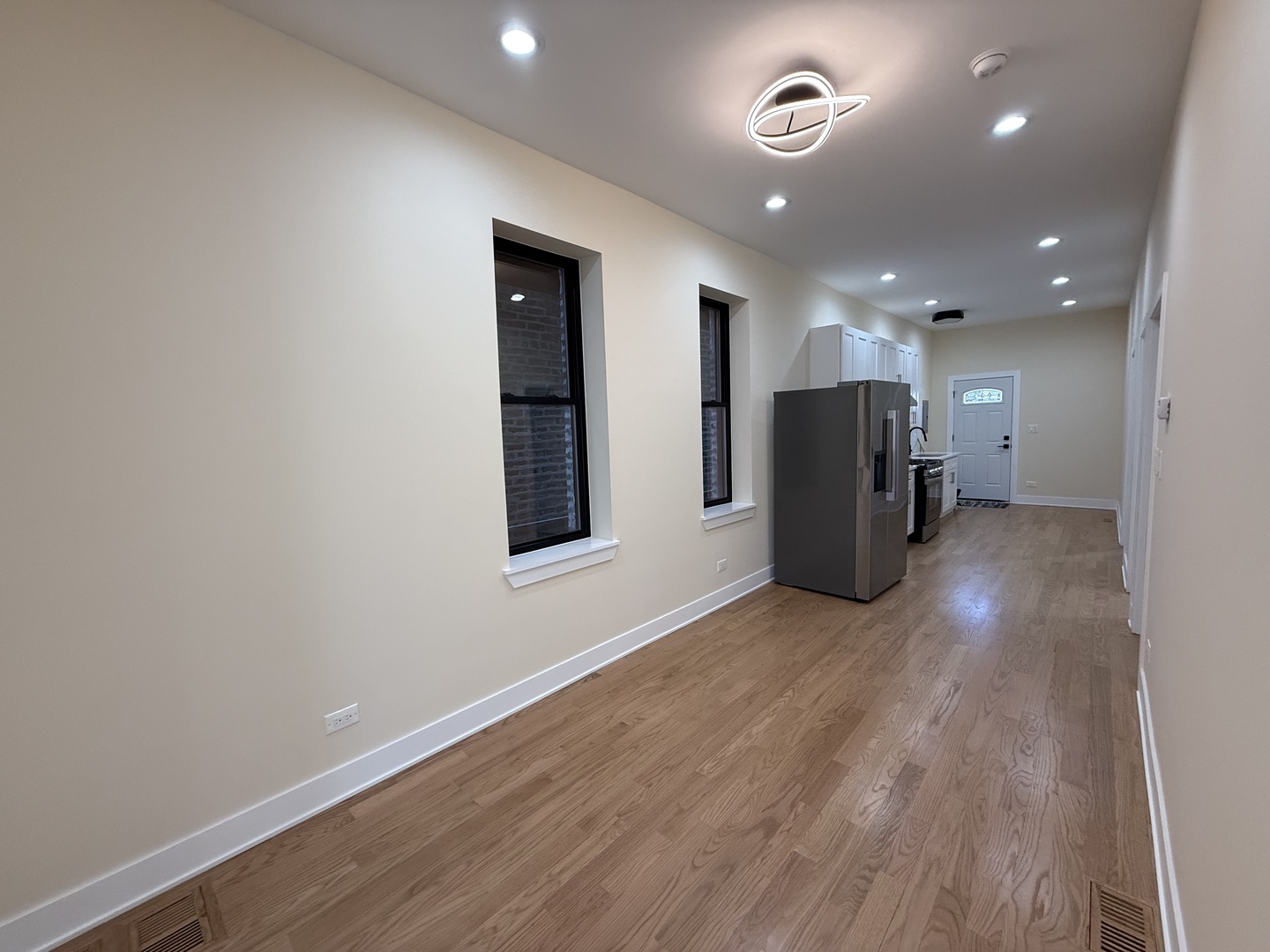 2124 West 18th Place, Unit 1 Chicago, IL 60608 - Photo 4 of 16 a view of an empty room with wooden floor