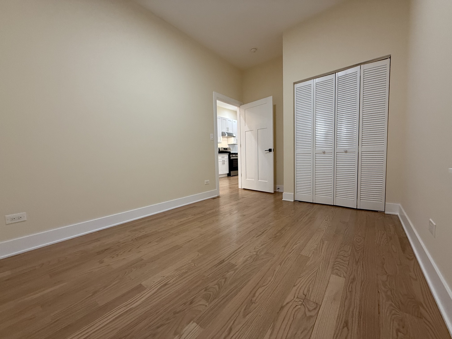 2124 West 18th Place, Unit 1 Chicago, IL 60608 - Photo 9 of 16 a view of a room with wooden floor and white walls
