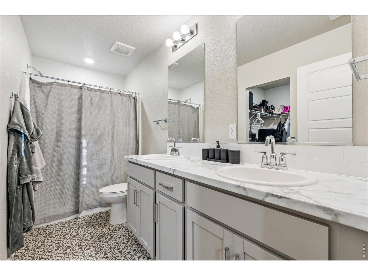 379 Beckwourth Avenue Fort Lupton, CO 80621 - Photo 13 of 26 a bathroom with a granite countertop sink a toilet and a mirror