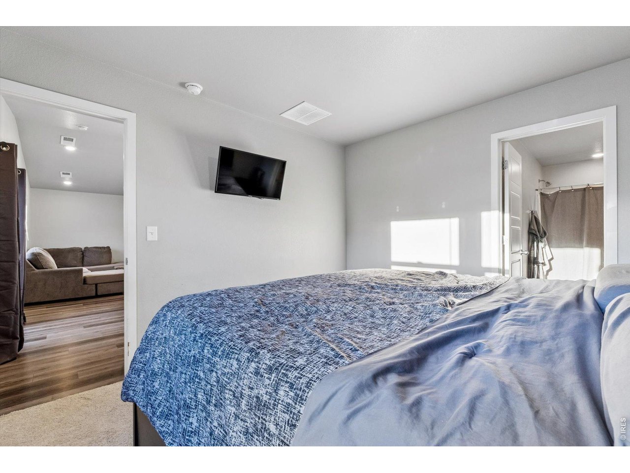 379 Beckwourth Avenue Fort Lupton, CO 80621 - Photo 14 of 26 a living room with a bed furniture and a flat screen tv