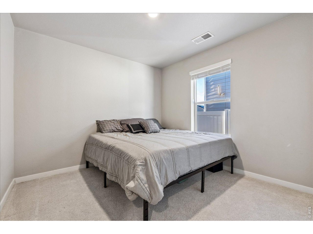 379 Beckwourth Avenue Fort Lupton, CO 80621 - Photo 18 of 26 a bedroom with a bed and a night stand