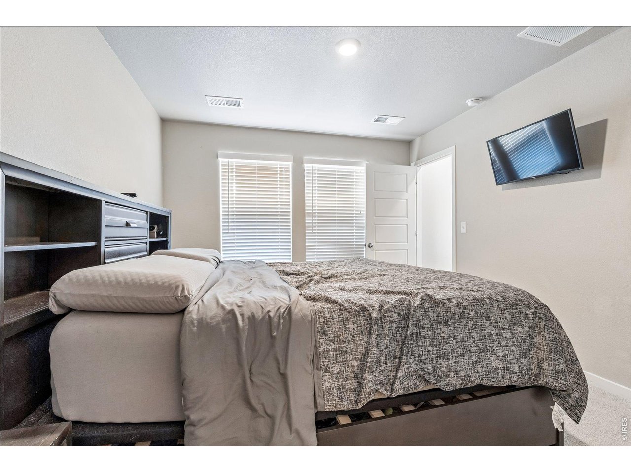 379 Beckwourth Avenue Fort Lupton, CO 80621 - Photo 20 of 26 a bedroom with a bed and a television