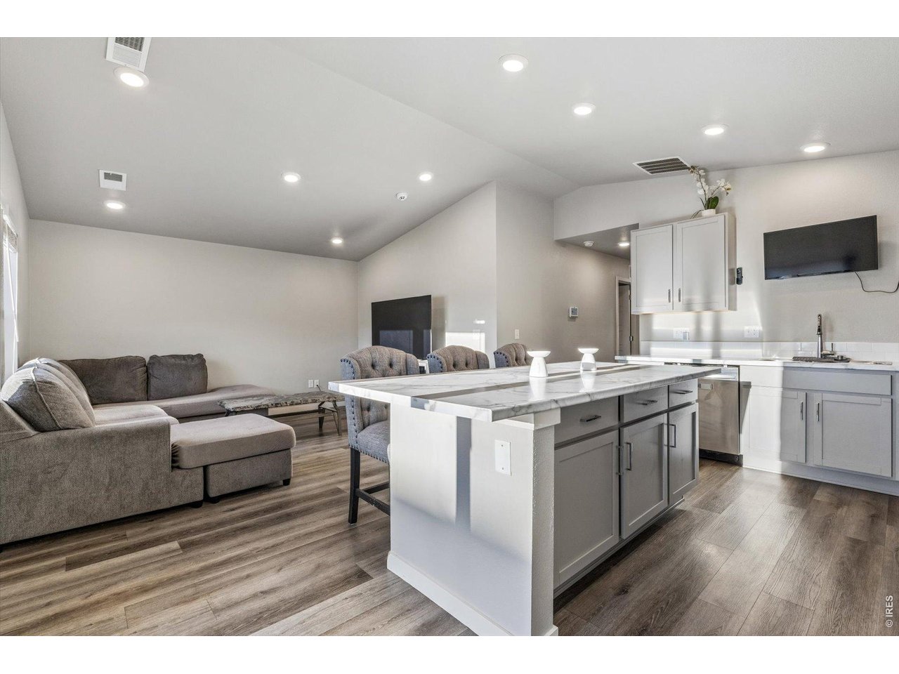 379 Beckwourth Avenue Fort Lupton, CO 80621 - Photo 8 of 26 a open kitchen with stainless steel appliances kitchen island granite countertop a sink and cabinets