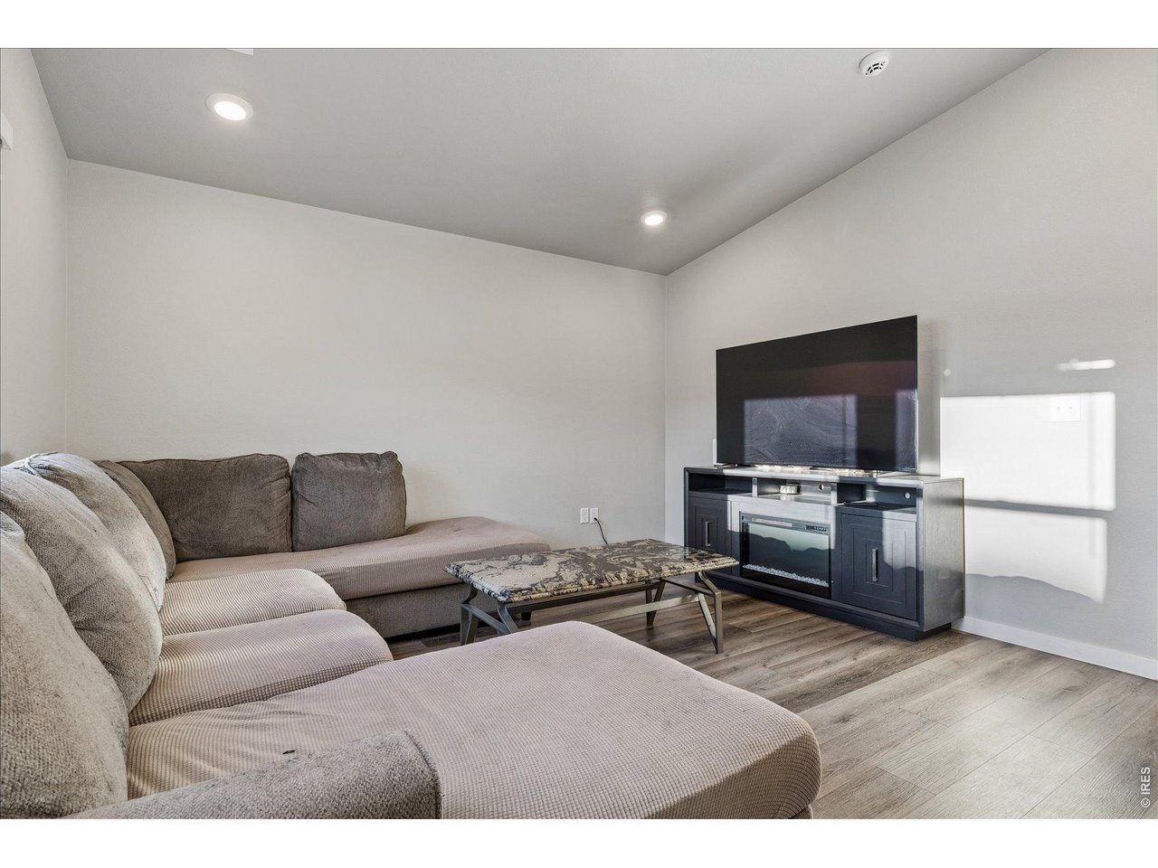 379 Beckwourth Avenue Fort Lupton, CO 80621 - Photo 10 of 26 a living room with furniture and a flat screen tv