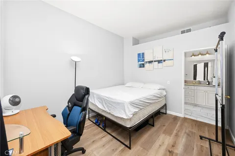 a bedroom with a bed and wooden floor