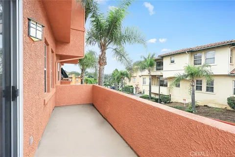 a view of balcony with a couple of potted plants