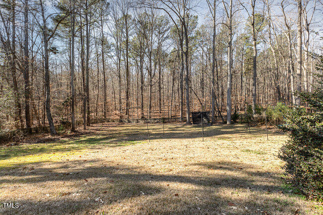 6613 Swallowtail Lane Raleigh, NC 27613 - Photo 6 of 7 a view of a swimming pool with a house in the background