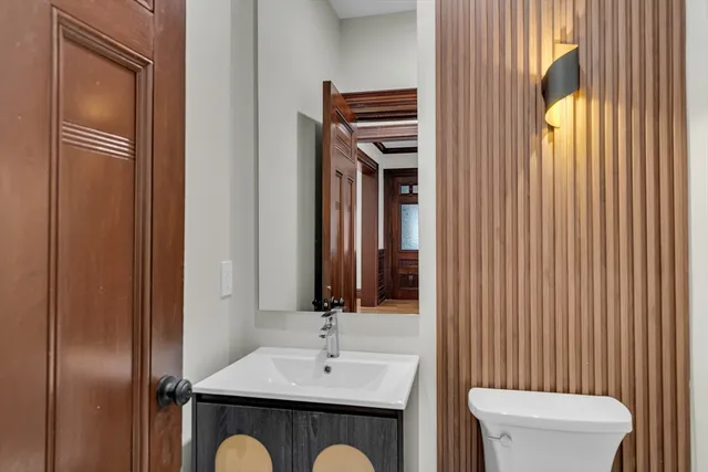 a bathroom with a sink a toilet and mirror