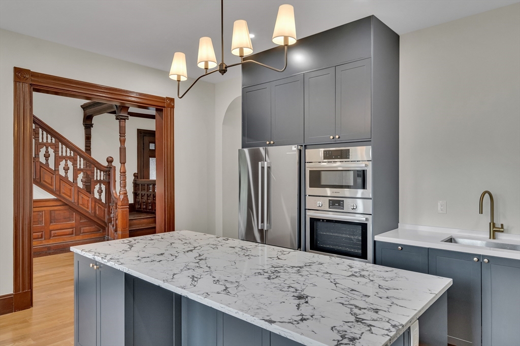 14-16 Summit Street Newton, MA 02458 - Photo 24 of 35 a kitchen with a table chairs and refrigerator
