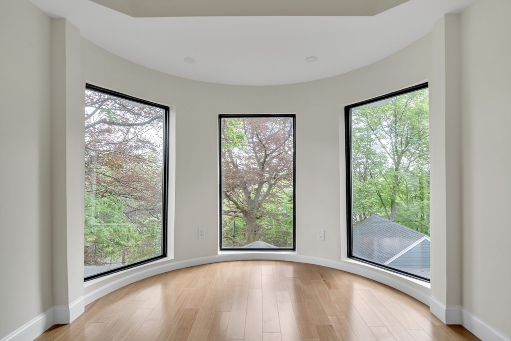 14-16 Summit Street Newton, MA 02458 - Photo 25 of 35 a view of an empty room with wooden floor and windows