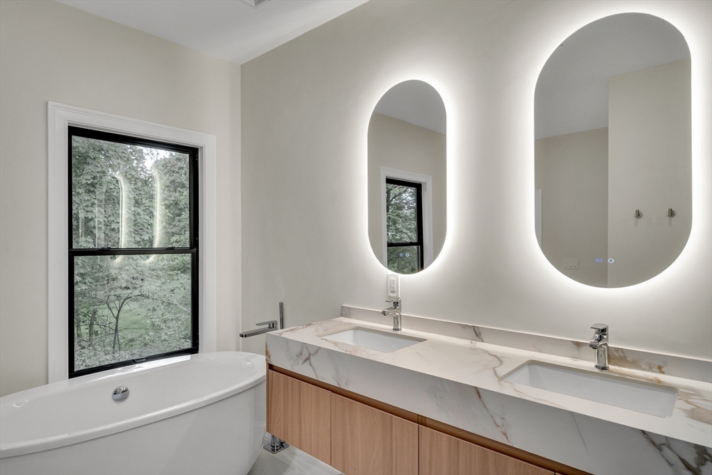 14-16 Summit Street Newton, MA 02458 - Photo 30 of 35 a bathroom with 2 sink and a mirror